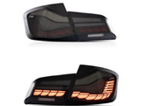 Two car taillights are shown. The top taillight is unlit, while the bottom taillight is illuminated with a segmented amber light pattern, on a plain white background.