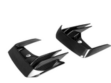 Carbon fiber car parts featuring sharp, angular fins and glossy finish; positioned against a plain white background, highlighting their sleek design and modern material.