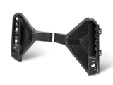 Carbon fiber bracket with geometric design, displaying attachment points. Positioned on a white background, highlighting its sleek, angular appearance. The material's texture is visibly detailed.