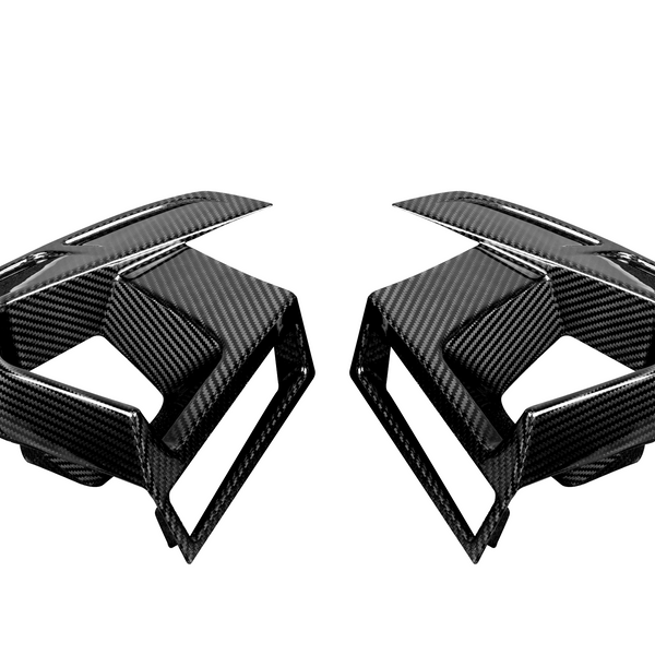 Two black carbon fiber car air vents, styled with sleek lines and sharp angles, face each other on a plain white background.