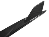 A carbon fiber surfboard featuring a sleek, curved fin is positioned against a plain white background, highlighting its modern and aerodynamic design.