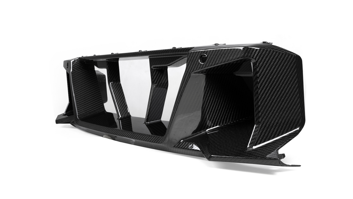 A carbon fiber car grille with angular vents is displayed on a plain white background, showcasing its glossy texture and intricate design.