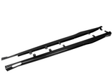Two long, black carbon fiber side skirts with mounting brackets lie side by side on a plain white background. The word 