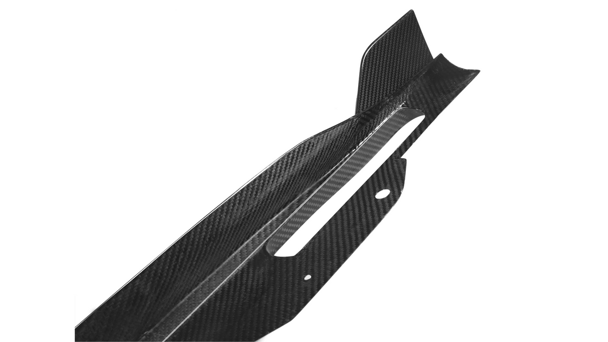 Carbon fiber car part features a sleek, angular design with cutouts and protrusions, set against a plain white background, suggesting high-performance automotive application.