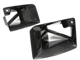 Two sleek carbon fiber car air intake vents are displayed against a plain white background, showcasing their glossy, angular design and texture.