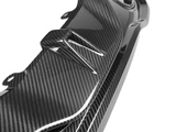 A glossy carbon fiber car part with aerodynamic fins is shown against a plain white background, emphasizing its sleek and modern design.