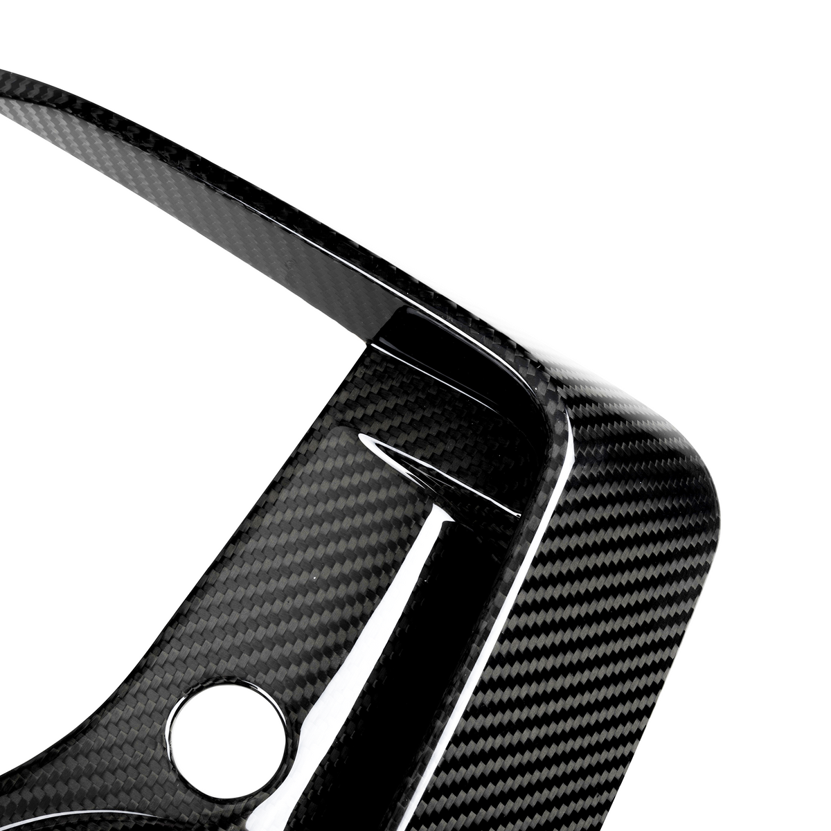 A carbon fiber car part features a curved, aerodynamic design with a circular hole, set against a plain white background.