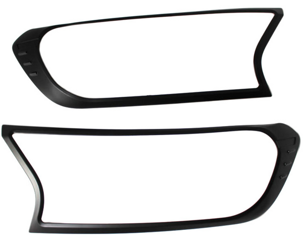 Two black plastic frames, resembling headlight covers, are positioned horizontally against a plain white background. Each frame has an asymmetric, modern design with smooth curves and sharp angles.