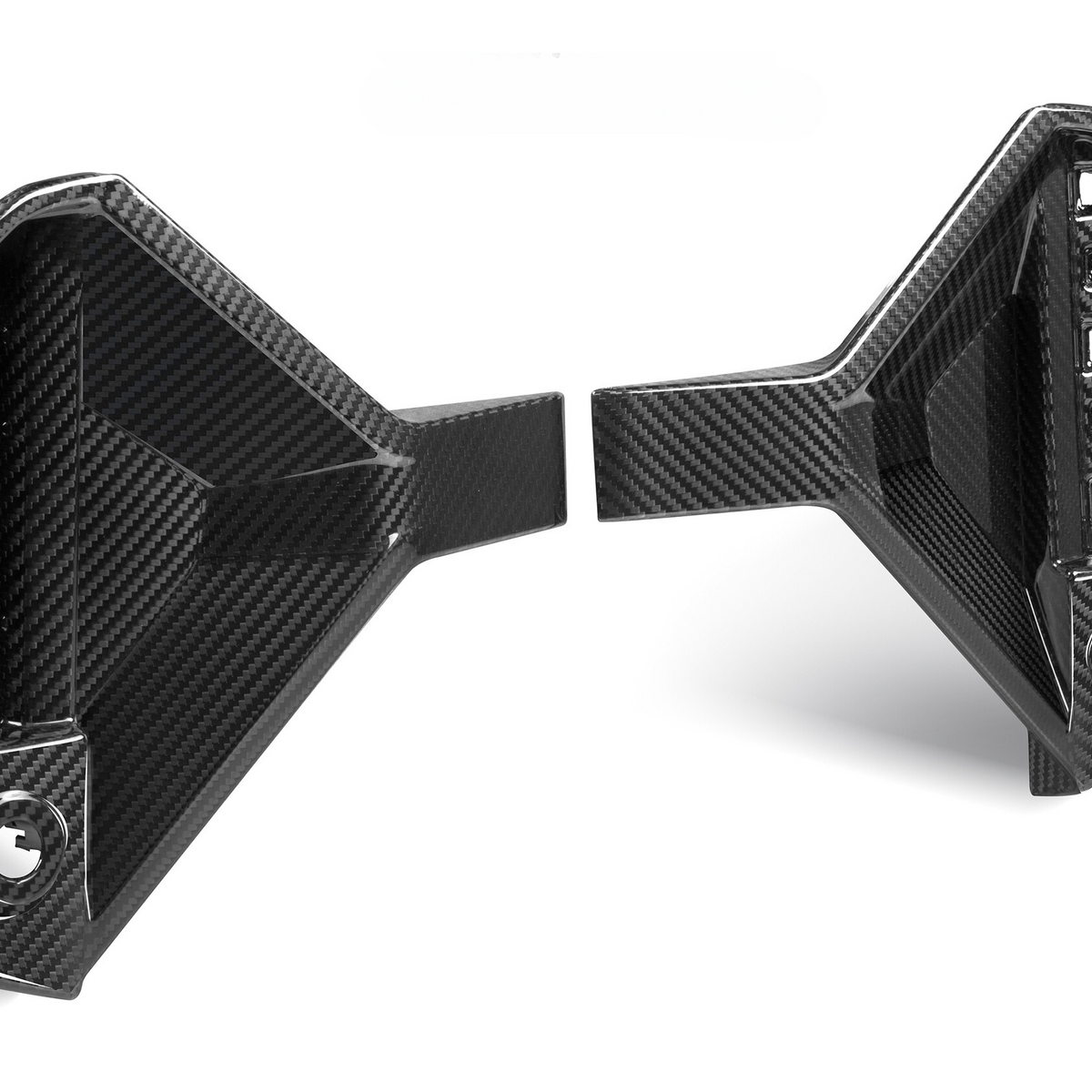 Two black carbon fiber car parts with angular designs are positioned facing each other. The left piece has visible attachment points; the right features an array of cutouts.