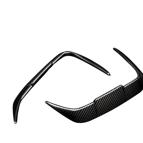 A pair of sleek, carbon fiber sunglass frames with pointed temples, positioned in a diagonal orientation against a plain white background.