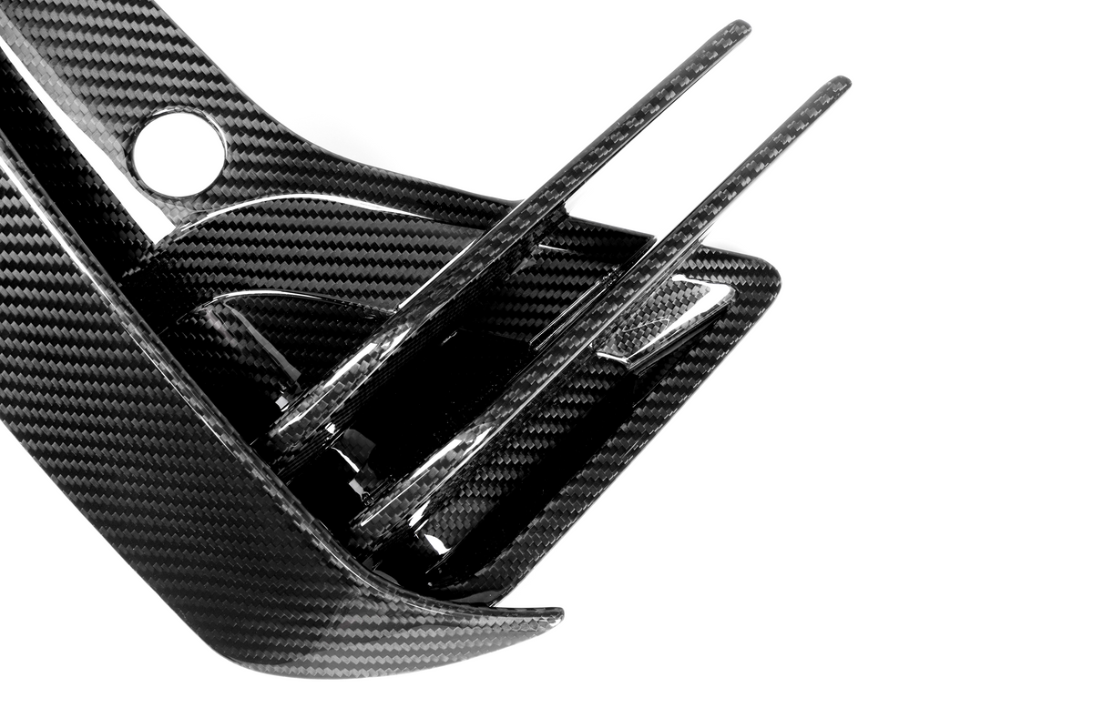 Carbon fiber component with sleek fins extending outward, set against a plain white background, showcasing a glossy, textured surface.