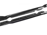 Two long, narrow, black carbon fiber side skirts with bolt holes lie parallel on a white background, designed for vehicle performance and aerodynamics enhancement.