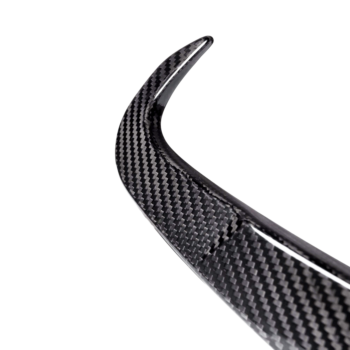 A curved carbon fiber piece, possibly a car spoiler, is shown against a plain, white background, highlighting its textured pattern and sleek design.