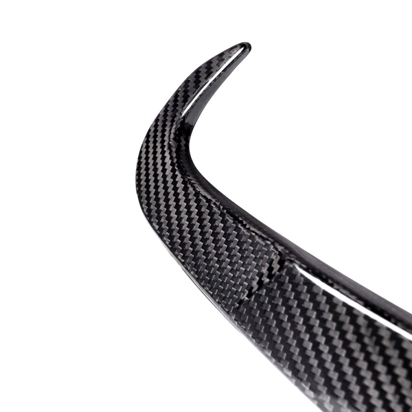 A curved carbon fiber piece, possibly a car spoiler, is shown against a plain, white background, highlighting its textured pattern and sleek design.