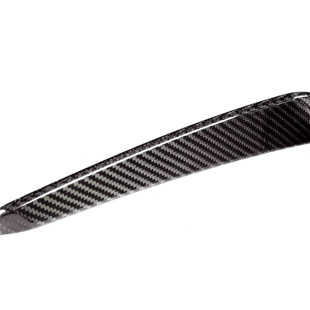 A carbon fiber component, featuring a sleek, curved design and glossy texture, appears isolated against a plain white background, showcasing its lightweight, woven pattern.