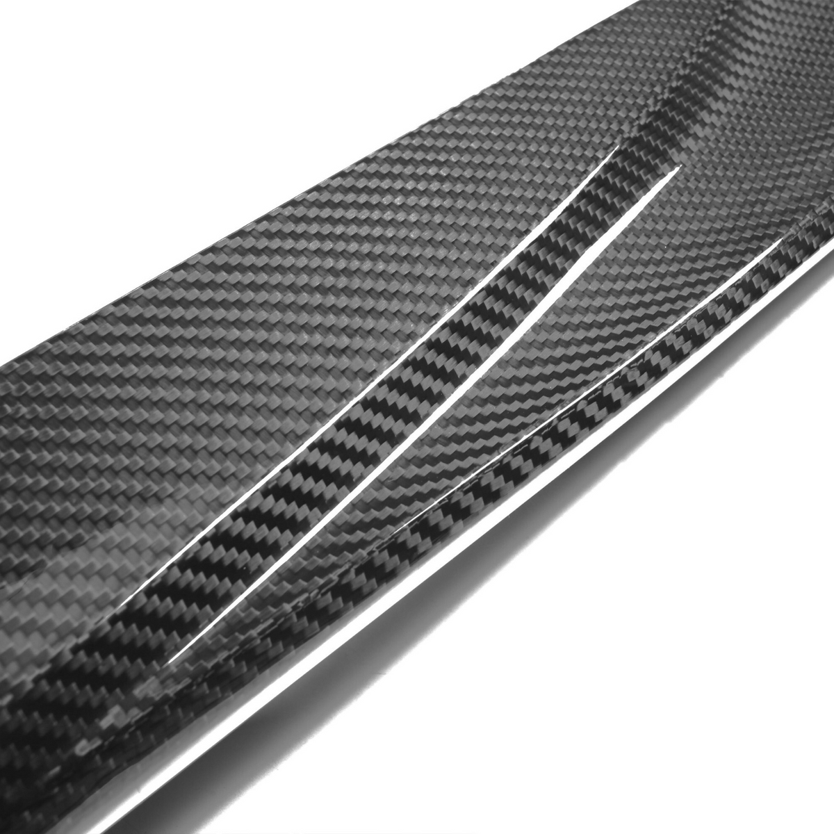 A shiny carbon fiber strip with a textured, checkered pattern is angled diagonally, reflecting light against a plain white background.