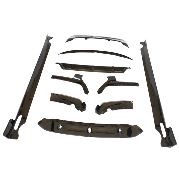 Car body kit components arranged on a white background, including aerodynamic parts like side skirts, bumpers, and wing pieces, all sleek and glossy, designed for vehicle customization.