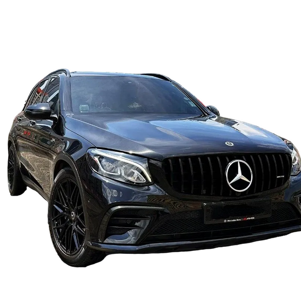 A black Mercedes-Benz SUV is parked on a rooftop, surrounded by Singapore city skyscrapers and red flags. The grill features the Mercedes logo prominently.