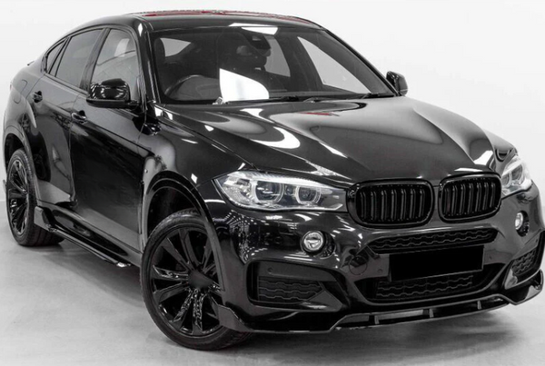 A black luxury SUV with sleek design features and large wheels is parked in a well-lit, plain indoor space, highlighting its glossy exterior and modern detailing.