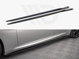 Two black side skirts lie parallel; below is a silver car with one skirt installed, resting on a textured gray floor.