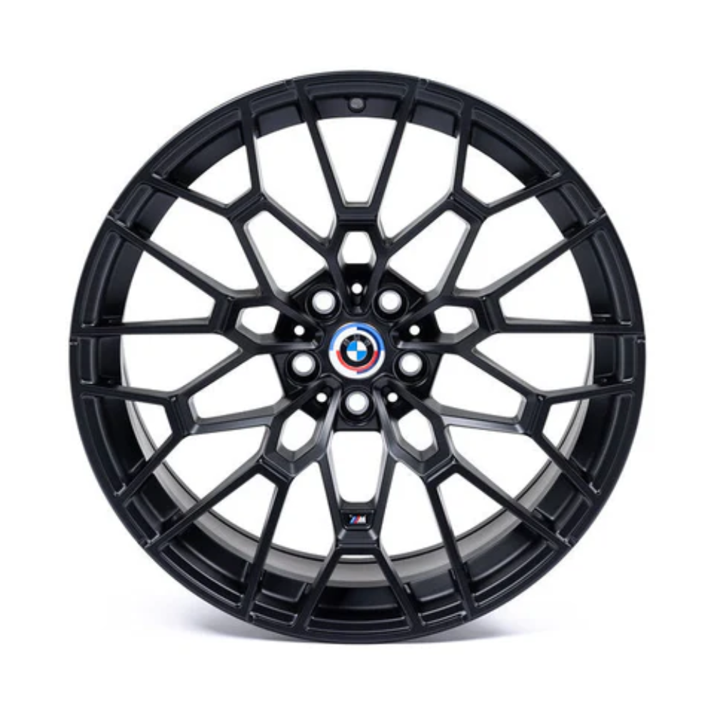 A black alloy wheel with a complex geometric spoke design features a BMW emblem at the center. It rests on a plain white background.