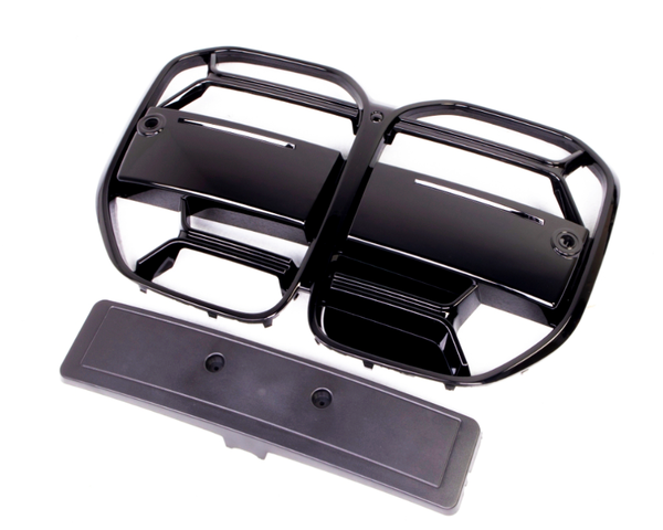 Black plastic vent covers with multiple horizontal slats are positioned on a white background. They appear detached and are accompanied by a long, rectangular panel below.