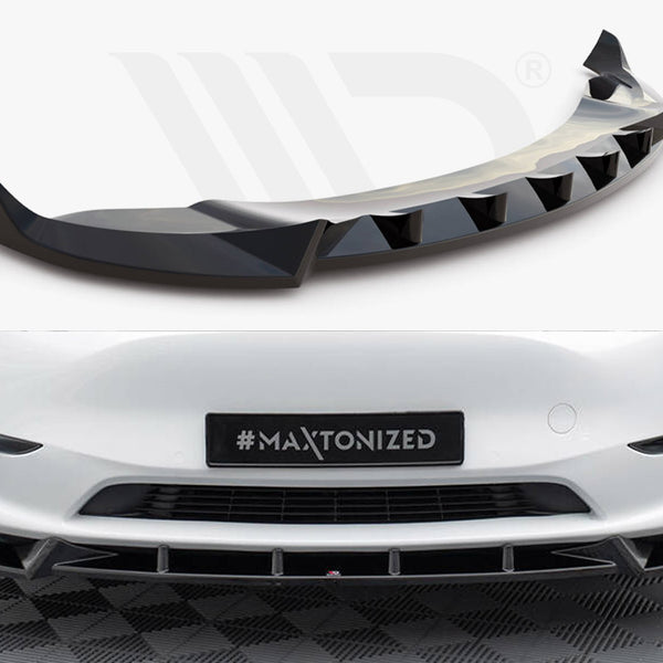 Aerodynamic car bumper extension with a sleek, black finish; installed on a white vehicle's front, which is parked on a checkered surface. License plate reads "#MAXTONIZED."