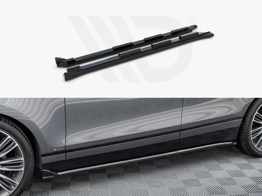 Two black side skirts are displayed above a partial view of a gray car parked on a patterned floor. The side skirts are aligned with the car's lower edge.