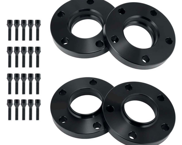 Four black wheel spacers with multiple bolt holes lay arranged symmetrically. Beside them, twenty-four black bolts stand in three vertical rows, contrasting the plain white background.