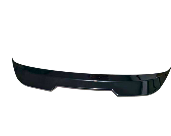 A black car spoiler rests against a white background, designed with a sleek, aerodynamic curve.