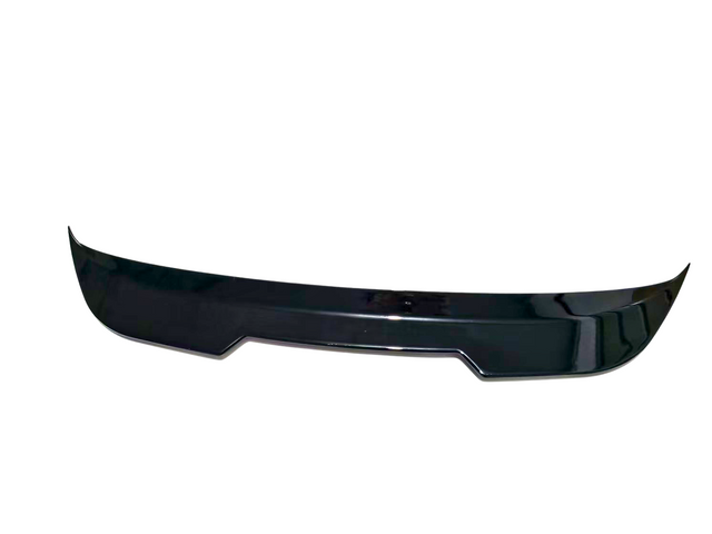 A black car spoiler rests against a white background, designed with a sleek, aerodynamic curve.