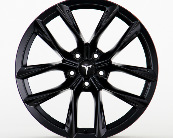 A black wheel rim featuring a sleek, multi-spoke design with the Tesla logo visible at the center, placed against a plain white background.