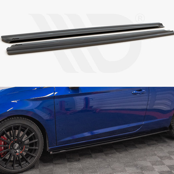 Two black car side skirts are shown above a blue sports car. The car features black wheels with red brake calipers and is positioned on a checkered floor.