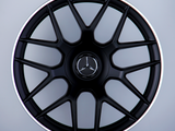 A black multi-spoke car wheel rim with a Mercedes-Benz logo at the center, labeled 