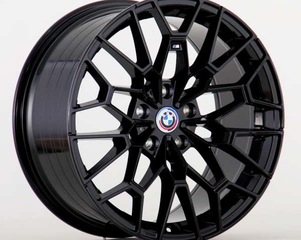 A black, multi-spoke car wheel with the BMW logo and an "M" badge in the center is displayed against a plain white background.