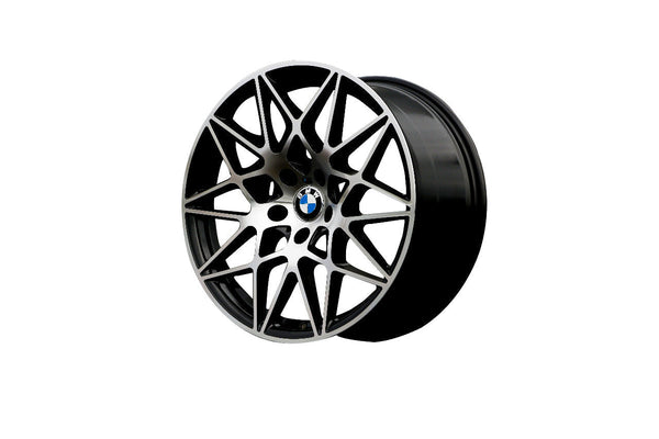 A black and silver alloy wheel with intricate spoke design and a BMW logo at the center, displayed against a plain white background.