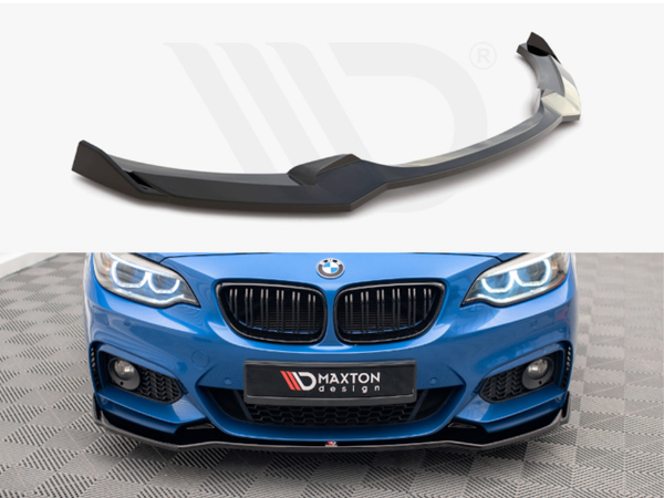 A black car front splitter rests on a white surface. Below, it is installed on a blue BMW, enhancing the sporty front design. The branded license plate reads "MAXTON design."