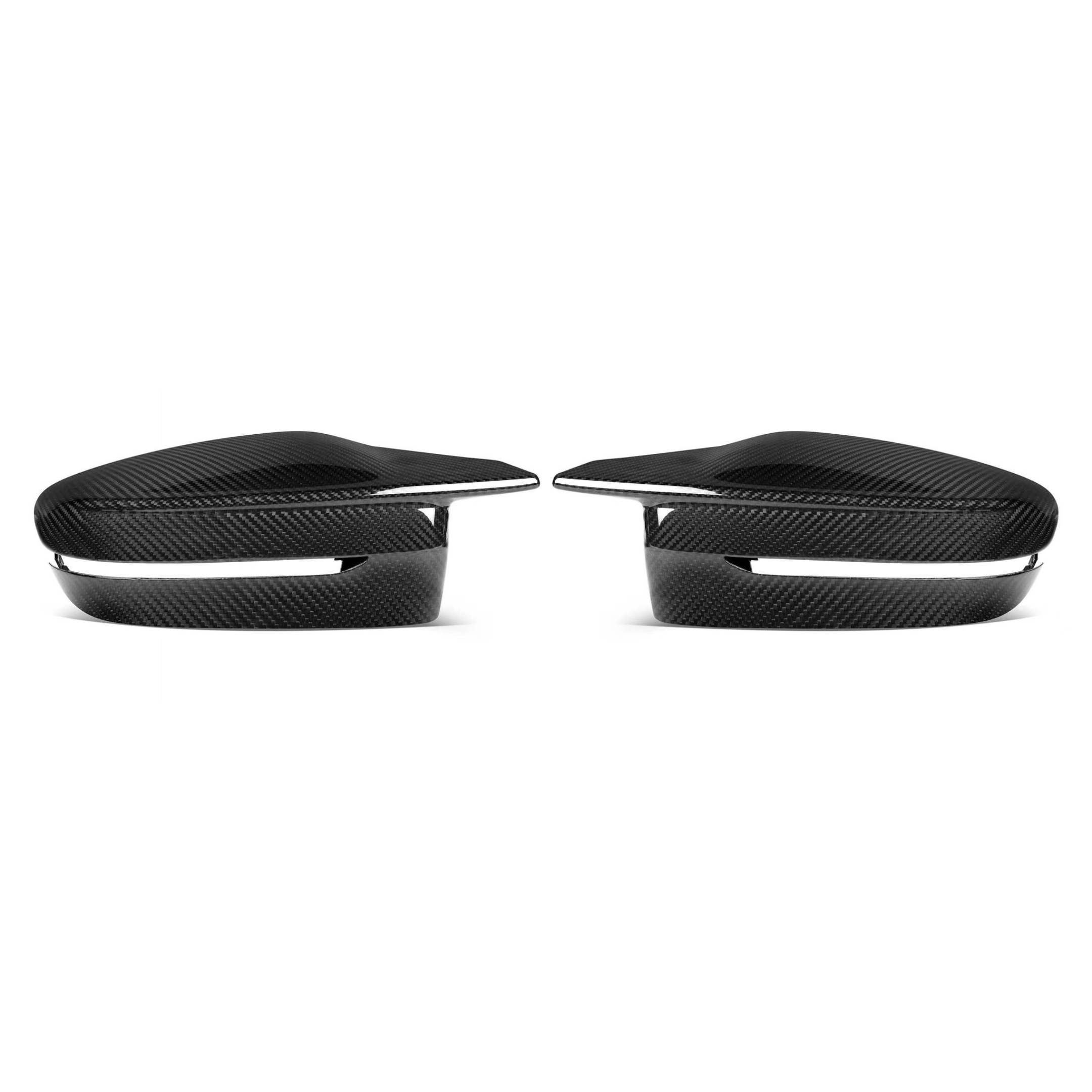 Two sleek, black carbon fiber car mirror covers are displayed against a white background, with an aerodynamic design that emphasizes a modern and futuristic aesthetic.
