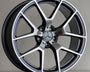 A silver alloy wheel with five double spokes, featuring a central Mercedes emblem, rests against a plain background. The rim displays the "AMG" logo.