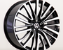 A black and silver alloy car wheel features a sleek, multi-spoke design with a Volkswagen logo at the center, positioned on a plain white background.