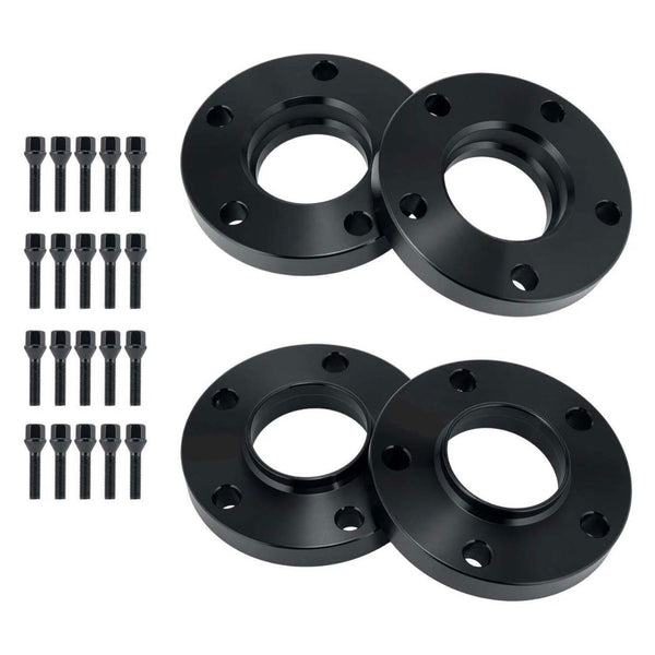 Four black wheel spacers with five bolt holes each and mounted screws are arranged diagonally. Black bolts accompany them, aligned vertically on a white background.