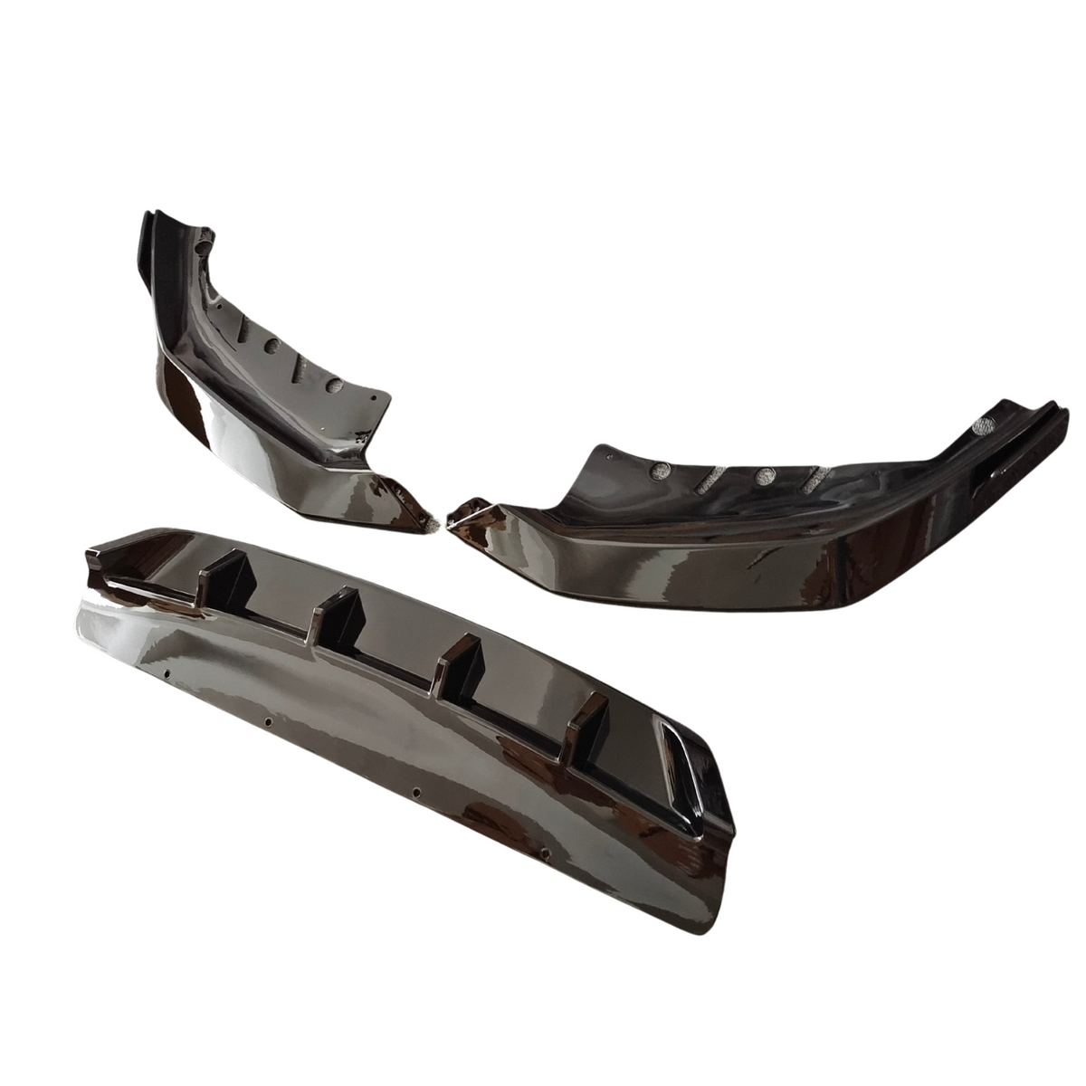 Three glossy, black bumper diffusers are arranged on a white background. Each piece features aerodynamic fins and a sleek, curved design, typically used for vehicle styling enhancement.