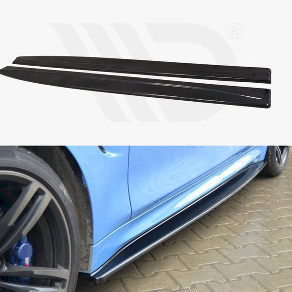 Two black car side skirts are displayed separately above a blue car with one installed, showing their fit along the vehicle's side, parked on a brick pavement.