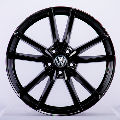 A glossy black car wheel rim with a Volkswagen logo at the center, featuring a split-spoke design, displayed against a plain white background.