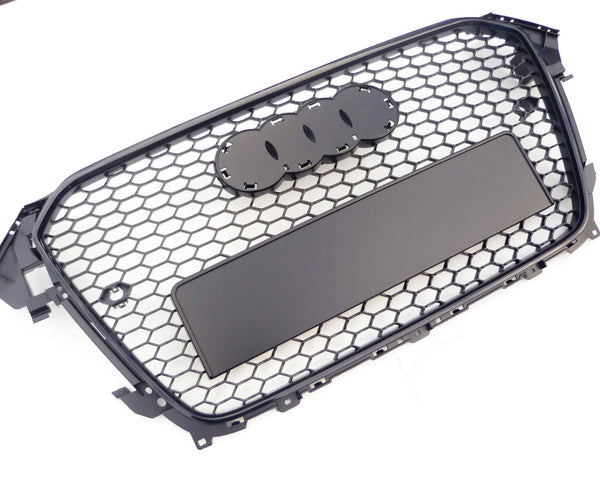 A black, hexagonal-patterned car grille with spaces for emblem attachment lies against a plain white background.