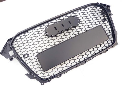 A black, hexagonal-patterned car grille with spaces for emblem attachment lies against a plain white background.