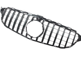 Black car grille with vertical bars and central circular opening; displayed on a white background.