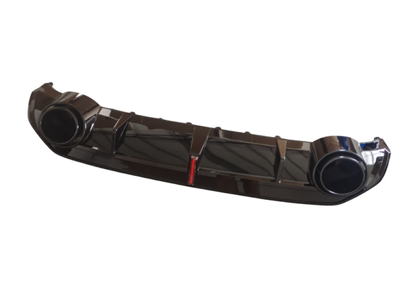 A glossy black car bumper with two circular exhaust ports is displayed against a plain white background, featuring a small red detail in the center.