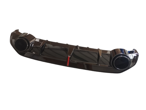 A glossy black car bumper with two circular exhaust ports is displayed against a plain white background, featuring a small red detail in the center.