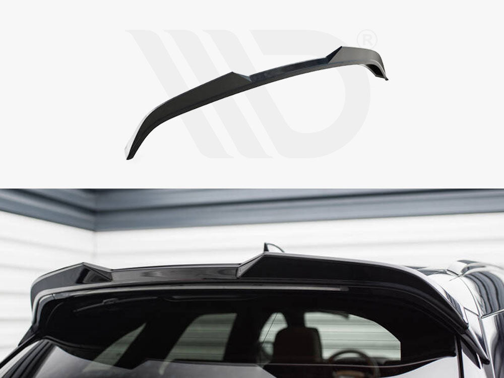 Black car roof spoiler installed on the rear of a vehicle, enhancing aerodynamics. The setting is a garage with gray and white walls, creating a sleek, modern atmosphere.